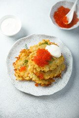 Homemade latkes with red caviar