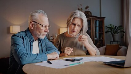 Senior couple looks at amount of payments and feels shocked