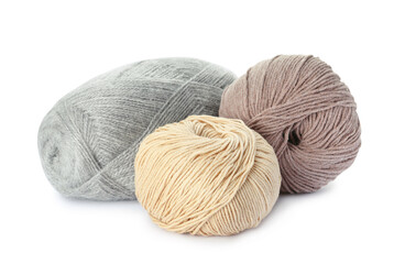 Different balls of woolen knitting yarns on white background