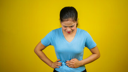 Young woman suffering from stomach ache, indigestion, menstruation, period cramp, stomachache,...