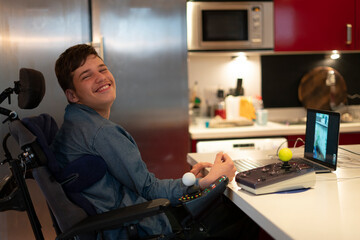 Portrait of disabled teenage boy using laptop