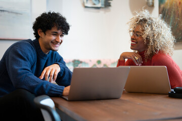 Creative professionals working on laptops in office