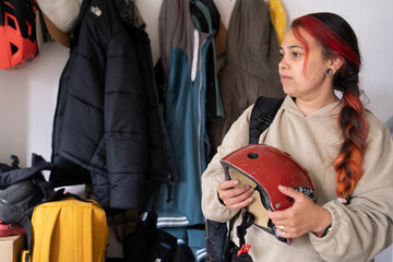 Woman holding sports helmet