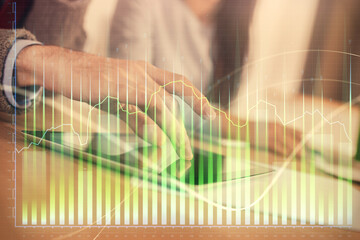 Double exposure of forex graph drawing and man and woman working together holding and using a mobile device. Trade concept.