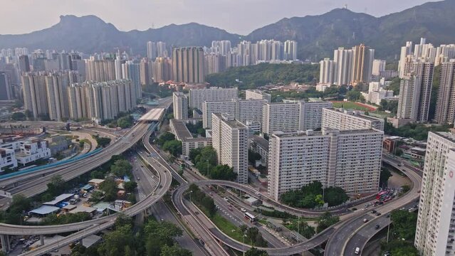 Aerial drone rotating shot over Choi Hung Estate, Kwun Tong Road, Kwun Tong Bypass, Tate's Cairn Highway, and Lung Cheung Road.