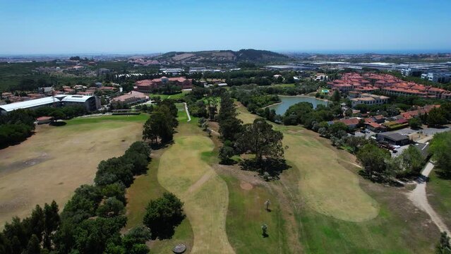 Aerial view over the Quinta da beloura golf course, in Sintra, Portugal	- tracking, drone shot