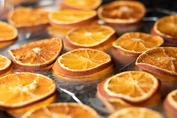 Background. Food. Oranges are cut into slices on a baking sheet baked in the oven. Close-up. Soft...
