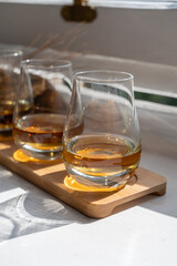 Flight of single malt scotch whisky served on old wooden window sill in Scottisch house in Edinburgh, Scotland, UK