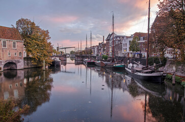 Rotterdam, The Netherlands, November 4, 2022: Aelbrechtskolk canal in Delfshaven neighbourhood under a colorful sky at dusk