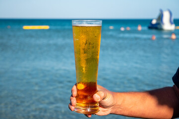 Pint of cold lager beer served in sunny beach bar on Cyprus