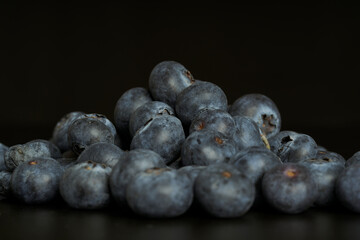 A group of fresh blueberries on a black background