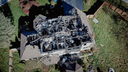 Fototapeta premium Toned photo burnt house with destroyed single roof of two story single family home in Rochester, New York, USA