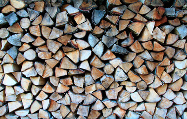 A lot of stacked woodpile, firewood. Selective focus. Background, texture