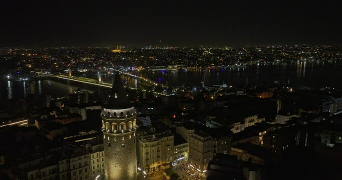 Istanbul Turkey Aerial v19 cinematic drone fly around historical landmark galata tower capturing european side neighborhood cityscape across golden horn at night - Shot with Mavic 3 Cine - July 2022