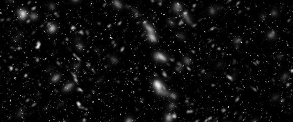 Falling snow isolated on black background. Falling snow at night. Bokeh lights on black background, flying snowflakes in the air. Winter weather. Overlay texture.
