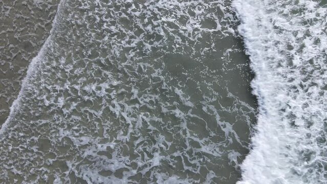 Aerial view of clear waves at beach