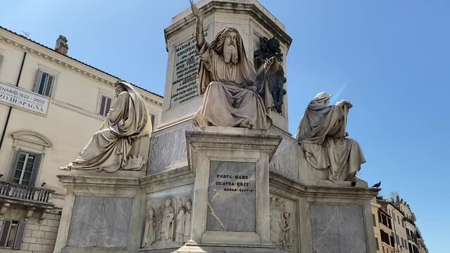 Biblical Column of the Immaculate Conception with the statue of Ezekiel the Seer in Rome, Italy near the Spanish Steps with a blue sky background.