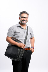 Young indian man holding laptop bag and standing on white background.