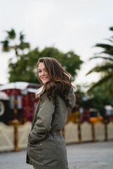 Young girl standing outside, wearing casual clothes