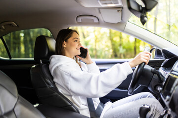 Businesswoman multitasking while driving talking on the phone