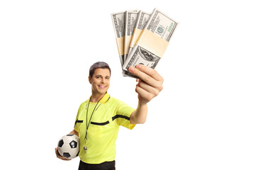 Football referee holding a ball and money