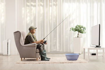 Fisherman fishing in a washing bowl in front of tv