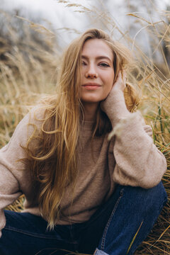 Close up outdoor portrait of young beauty blondie caucasian girl in field