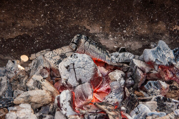 Flaming Charcoal In BBQ Grill Pit Isolated On Black Background