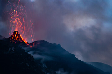 Active volcano eruption at night on Stromboli island in Italy