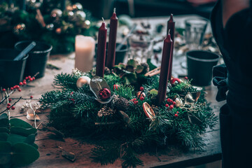 preparation of traditional advent wreath with candles from natural components, pine fir and adorns - 544888274