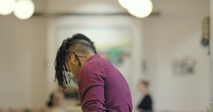 Portrait of man with dreadlocks in office