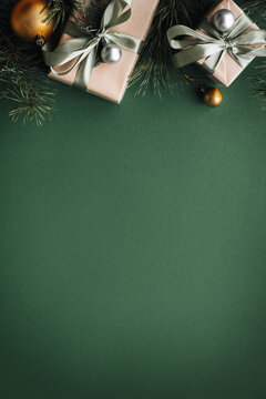 Vertical banner with many gift boxes with paper decorations on olive background. Christmas background.
