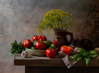 Rustic still life with vegetables and herbs on a wooden table