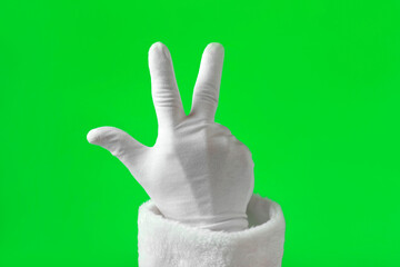 Santa Claus Hand Showing Three Fingers on Chroma Key Background. Hand in White Gloves Gesturing Count Isolated on Green Screen. Calculating. Palm with Fingers. Starting Point. Counting Number 3.