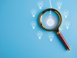 magnifying glass focus on light bulb for creative new idea, brainstorming, inspiration, and...