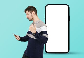 Mobile offer. Indian Pakistani man with giant smartphone mockup. Man using mobile advertising or promoting app or websites. Man with Cellphone. Happy Indian Man looking at mobile screen. Mobile Mockup