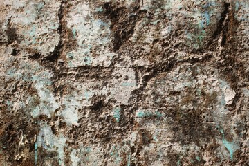 background concept using old cracked wall material, peeling wall surface forming abstract art, old wall background full of cracks and moss