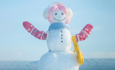 Fashion funny snowman on the snow outdoor background. Christmas banner with fashionable snowman....