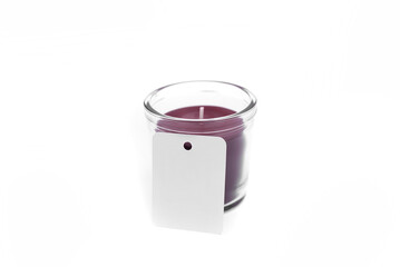 A candle in a glass cup. On a white background.