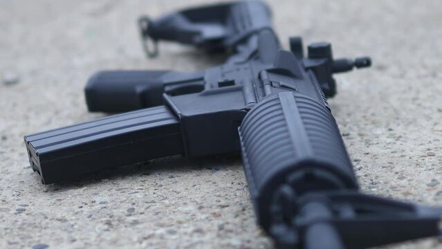 Detail of an automatic rifle on the ground
