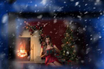 Fototapeta na wymiar portrait of nice woman in red dress near christmas tree