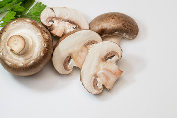 Baby brown mushrooms on a white cutting board