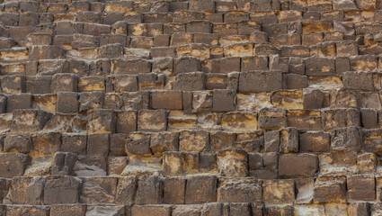 Background image of the stone blocks of the pyramid of Cheops on the Giza plateau in Egypt