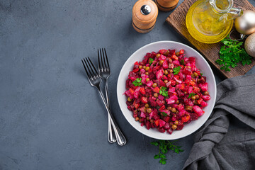 A portion of vegetable salad, vinaigrette on a graphite background. Top view, copy space