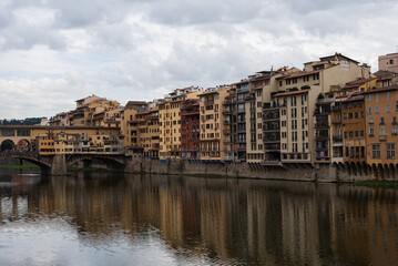 Fototapeta na wymiar Bridge over the river Arno. Bank of the river Arno in Florence, Italy. Reflection. 