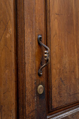 old wooden door with handle and lock, close up