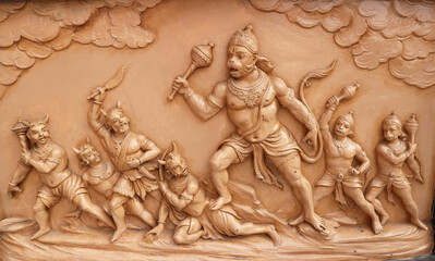 Hanuman fights demons. A story from the Ramayana on a temple wall in Rishikesh, Uttarakhand, India