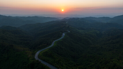 andscape shadow of valley and thin mist caused by light of sunset in evening and Road No.1081 also hnow as Sky Road, winding along ridge between Pua Distric, Nan Province, is beautiful route north 