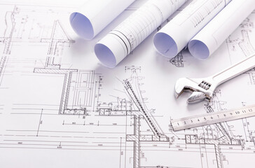 rolls of architectural drawings and tools