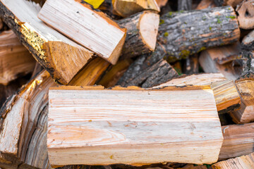 A pile of firewood chopped close-up for heating a house in the countryside